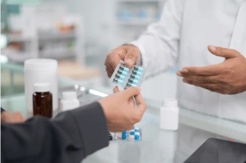 Pharmacist organising prescription medication at Batu Pharmacy